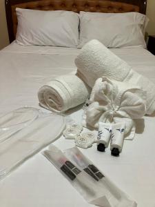 a bed with towels and rolled up towels on it at Sandingan Homestay in Loon +14 photos