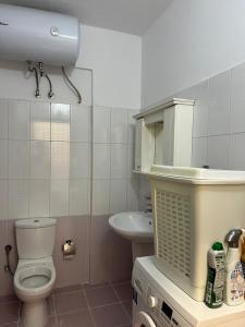 a bathroom with a toilet and a sink at Saranda Spot Apartment in Sarandë +11 photos