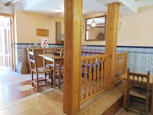 a kitchen and dining room with a table and chairs at Hostal San José in Naval