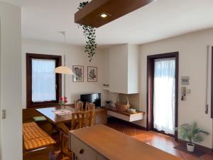 a kitchen and living room with a table and a dining room at 10 minuti a piedi dal centro - Zona Tranquilla e Silenziosa in Asiago