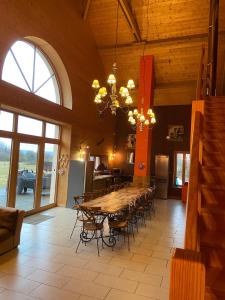 a large dining room with a table and chairs at Le MARLAYA PROCHE DU LAC DE VOUGLANS in Charchilla +12 photos