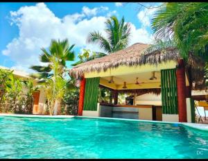 a swimming pool in front of a villa at Hotel Boutique Bahia Azul in Bacalar