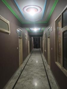 a corridor in a building with a ceiling at Hotel Royal Place in Rāmpur