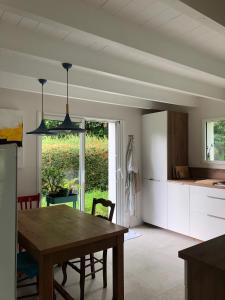a kitchen and dining room with a table and a window at Trouz An Dour in Fouesnant