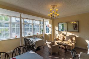 a living room with a couch and a table at Rooms at The Highcliffe in Aberporth
