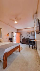 a large bedroom with a bed and a kitchen at Flat Vila Maria in Marechal Deodoro