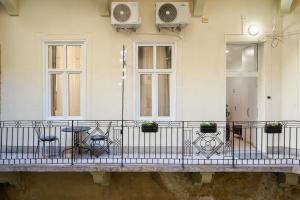 a balcony with chairs and a table on a building at D20 - Gozsdu Garden Residence - Best Location by BQA in Budapest