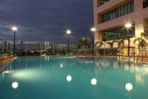 a large pool of blue water in front of a building at Richone Maluri Private Hotel in Kuala Lumpur