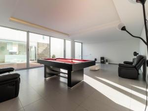 a living room with a pool table and two chairs at Akivillas Sintra Stone in Sintra