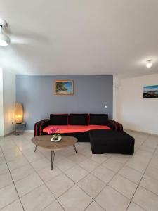 a living room with a couch and a table at Les Hauts de Beline Petit-Havre in Le Gosier +31 photos