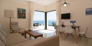 a living room with a couch and a table at Angelbay Bungalows in Agia Triada