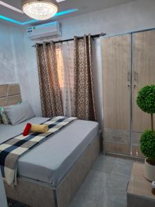 Katil atau katil-katil dalam bilik di Seckebe Immo Et Business Studio Gris