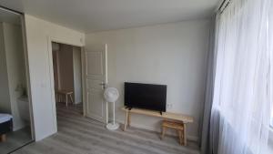 a living room with a flat screen tv on a table at Tiny cozy apartment 'Unihus' in Varėna