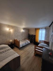 a hotel room with two beds and a window at Gîte Chez Angela in Bar-sur-Aube