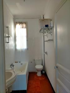 a white bathroom with a toilet and a sink at L'Essentiel à Nice in Nice +12 photos