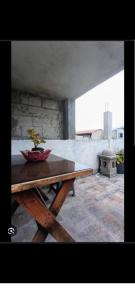 a wooden table with a plant sitting on top of it at Pacífico Jaguar Antigua in Antigua Guatemala