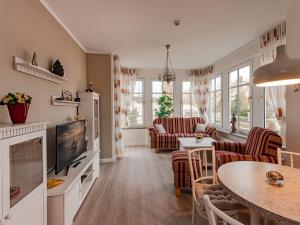 a living room with a television and a table at Villa Christiane Wohnung 8 in Heringsdorf