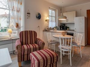 a kitchen with a table and chairs and a refrigerator at Villa Christiane Wohnung 8 in Heringsdorf