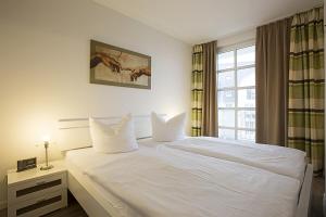 Ένα ή περισσότερα κρεβάτια σε δωμάτιο στο Residenz am Balmer See - BS 12 mit Wellnessbereich