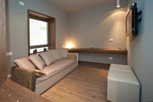 a living room with a couch and a window at Hotel Carla in Levanto