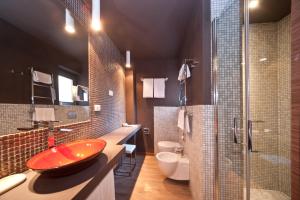 a bathroom with a red sink and a shower at Hotel Carla in Levanto
