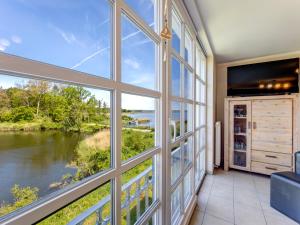 a room with a large window looking out at a river at Residenz am Balmer See - BS 69 mit Wellnessbereich in Balm