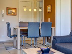 a room with a table and chairs and a couch at Residenz am Balmer See - BS 69 mit Wellnessbereich in Balm