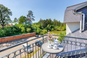 a table on a balcony with a view of a river at Residenz am Balmer See - BS 71 mit Wellnessbereich in Balm