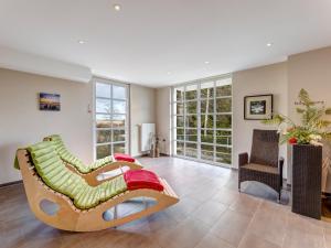 a living room with a couch and a chair at Residenz am Balmer See - BS 11 mit Wellnessbereich in Balm