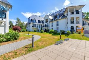 a large white building with a park in front of it at Residenz am Balmer See - BS 11 mit Wellnessbereich in Balm +19 photos