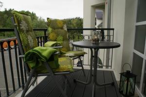 a balcony with a table and chairs on a balcony at Residenz am Balmer See - Kleine Auszeit - BS 21 mit Wellnessbereich in Balm