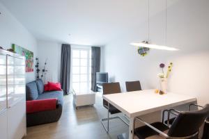 a living room with a table and a dining room at Residenz am Balmer See - BS 09 mit Wellnessbereich in Balm