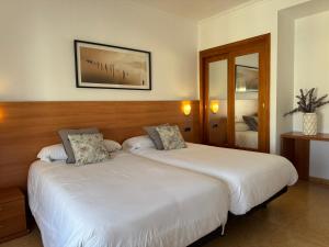 Postel nebo postele na pokoji v ubytování Hotel Ciudad Pozo Alcón