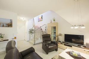 a living room with a couch and a television at Residenz am Balmer See - BS 31 mit Wellnessbereich in Balm