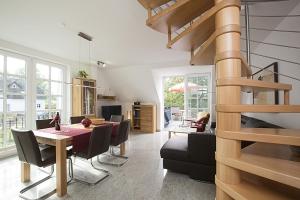 a dining room and living room with a table and chairs at Residenz am Balmer See - BS 32 mit Wellnessbereich in Balm