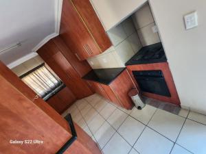 an overhead view of a kitchen with wooden cabinets at Wampex Guest House in Rustenburg