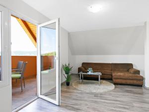 a living room with a couch and a mirror at Apartment Beate by Interhome in Badacsonytomaj +34 photos