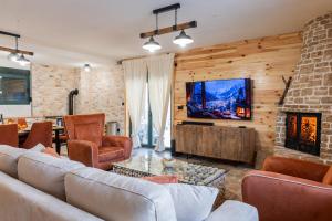 a living room with a couch and a fireplace at Villa Vucje near Kolasin in Kolašin