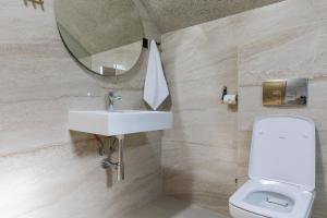 a bathroom with a sink and a toilet and a mirror at Villa Vucje near Kolasin in Kolašin +15 photos