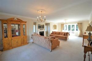 a living room with two couches and a chandelier at Lavish4Bed Mansion in Warrington in Warrington