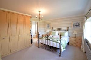 a bedroom with a bed and a chandelier at Lavish4Bed Mansion in Warrington in Warrington