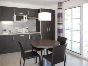 a kitchen with a dining room table and chairs at Apartment Villas du Spa-4 by Interhome in Pléneuf-Val-André