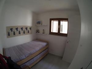 Postel nebo postele na pokoji v ubytování La Perla del Mare