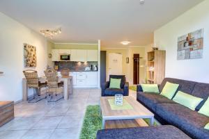 a living room with a couch and a table at Residenz am Balmer See - BS 42 mit Wellnessbereich in Balm