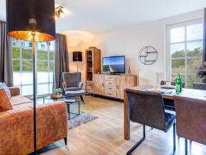 a living room with a table and a couch at Residenz am Balmer See - BS 43 mit Wellnessbereich in Balm