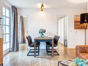 a dining room with a table and chairs at Residenz am Balmer See - BS 43 mit Wellnessbereich in Balm