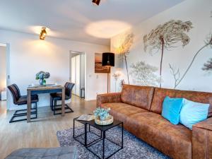 a living room with a couch and a table at Residenz am Balmer See - BS 43 mit Wellnessbereich in Balm