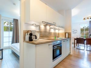 a kitchen with a sink and a counter top at Residenz am Balmer See - BS 43 mit Wellnessbereich in Balm