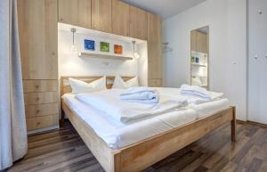 Ostseeresidenz Gorki- Park - 09 mit Wellness und Schwimmbad في بانسين: سرير كبير عليه شراشف بيضاء ومناشف زرقاء +19 صورة