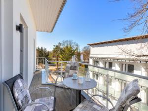 a patio with a table and chairs on a balcony at Ostseeresidenz Gorki- Park - 24 mit Wellness und Schwimmbad in Bansin